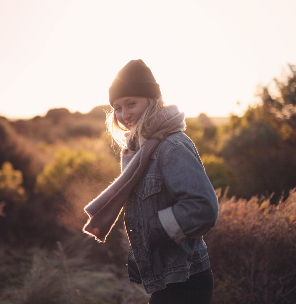 Smiling woman outdoors at sunset