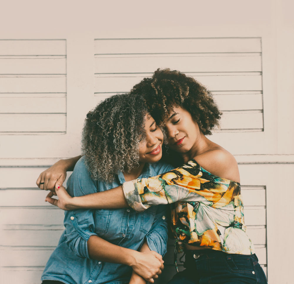 Two women hugging each other